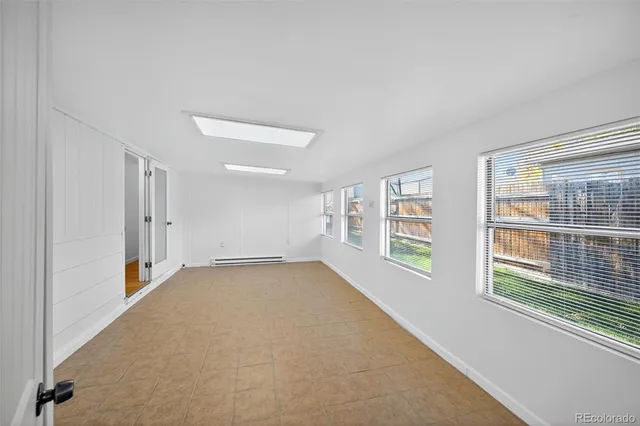 a open kitchen with cabinets and wooden floor