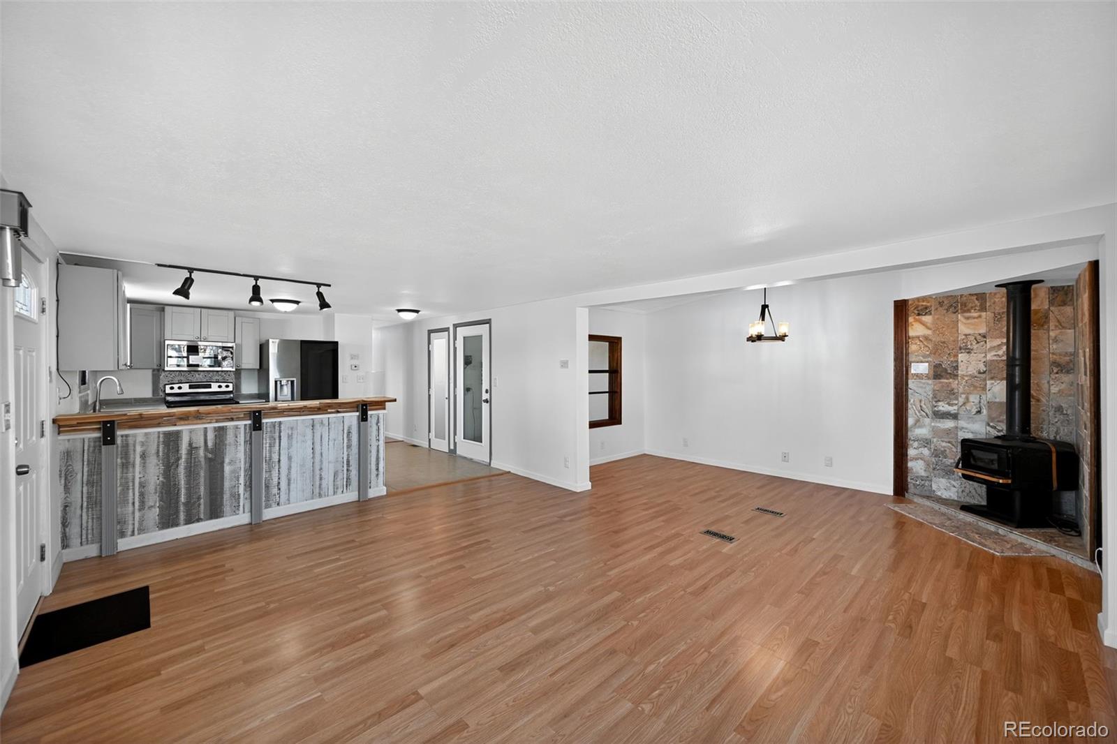 2000 Moselle Street Denver, CO 80260 - Photo 25 of 33 a open kitchen with cabinets and wooden floor