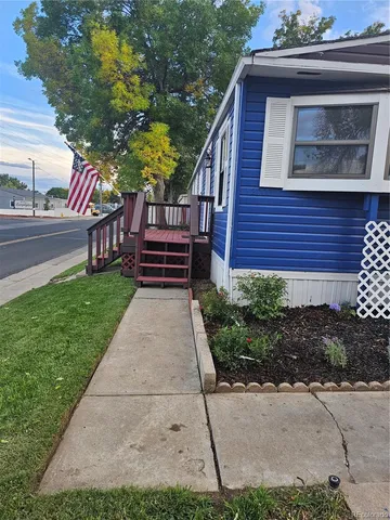 a view of a house with a small yard and wooden fence