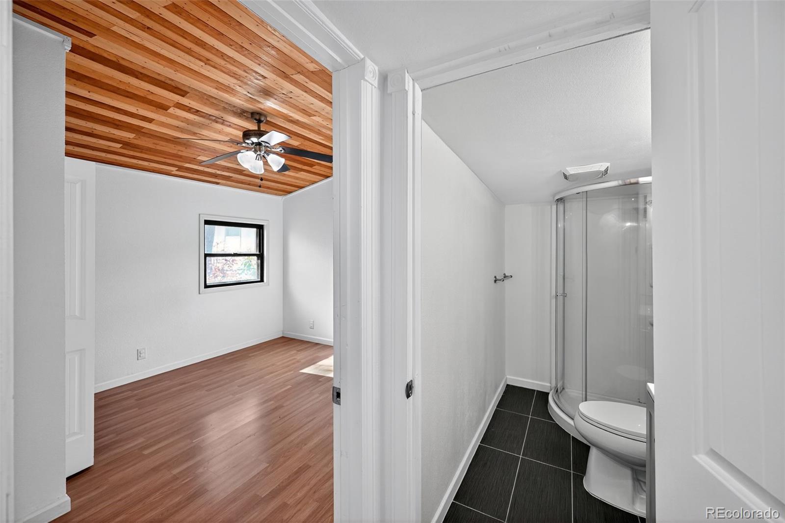 2000 Moselle Street Denver, CO 80260 - Photo 5 of 33 a view of a room with wooden floor and a bathroom