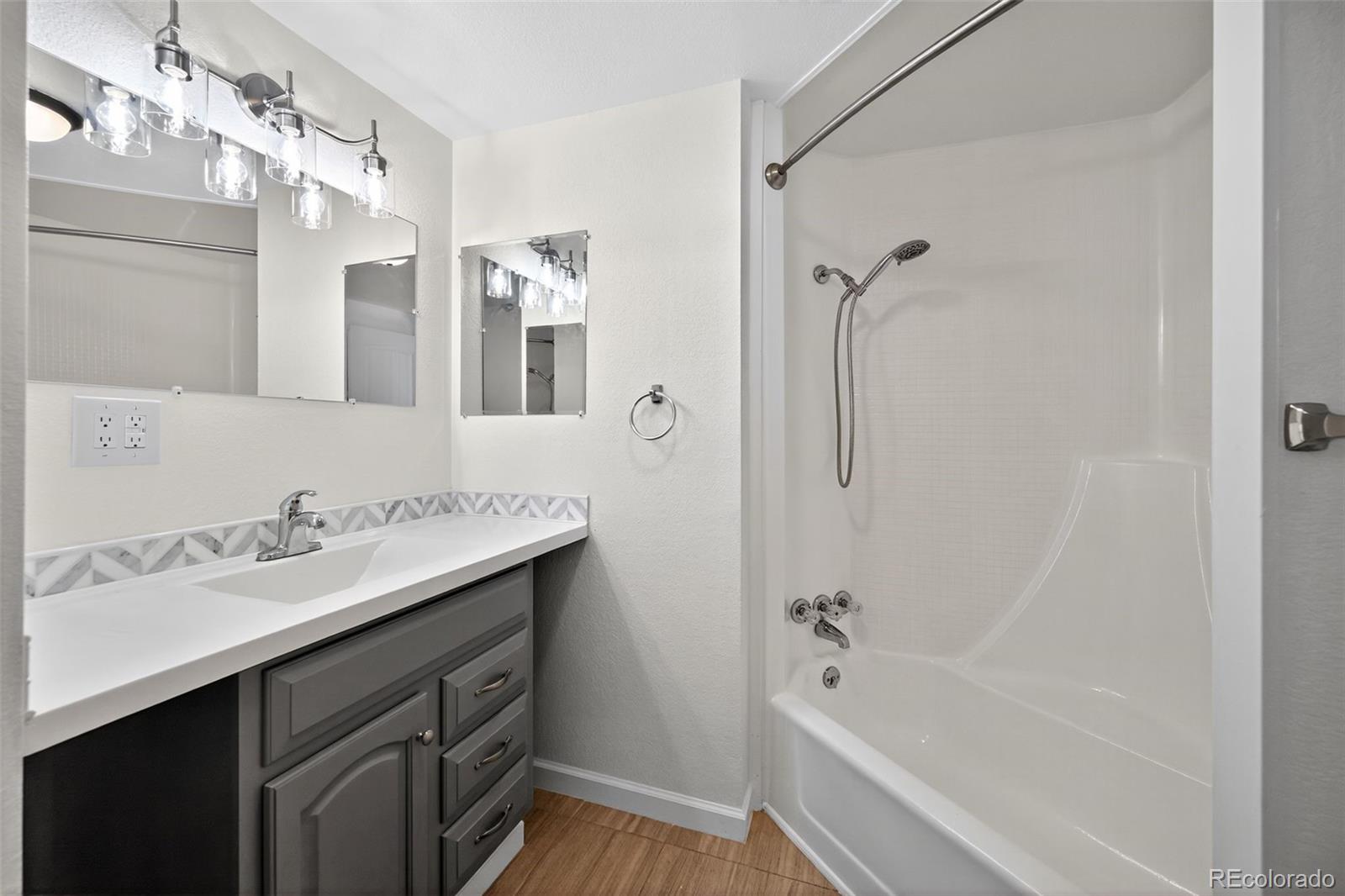 2000 Moselle Street Denver, CO 80260 - Photo 6 of 33 a bathroom with a tub sink shower and mirror