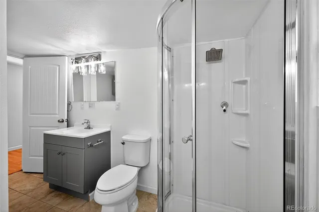 a spacious bathroom with a shower sink and mirror