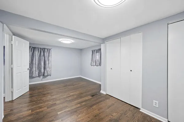 a view of an empty room with wooden floor