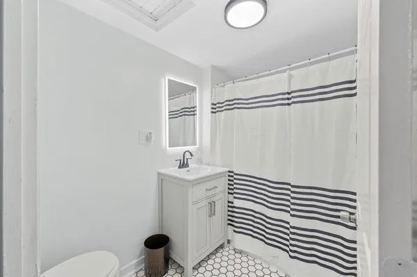 a bathroom with a sink toilet and shower
