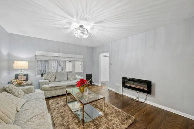 a living room with furniture and a chandelier