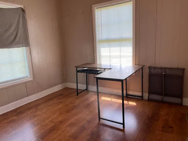 a view of a workspace with furniture and window