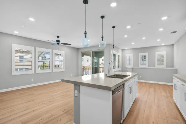 a kitchen with stainless steel appliances granite countertop a sink a oven and a hard wood floor