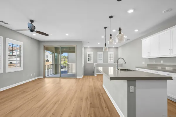 a large kitchen with kitchen island white cabinets and stainless steel appliances