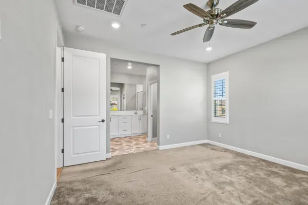 en empty room with fan and entrance