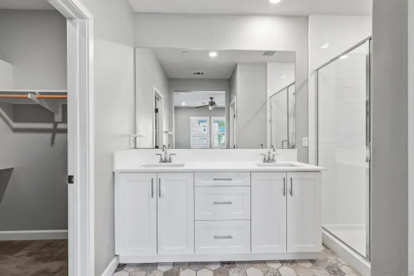 a bathroom with mirror and a sink