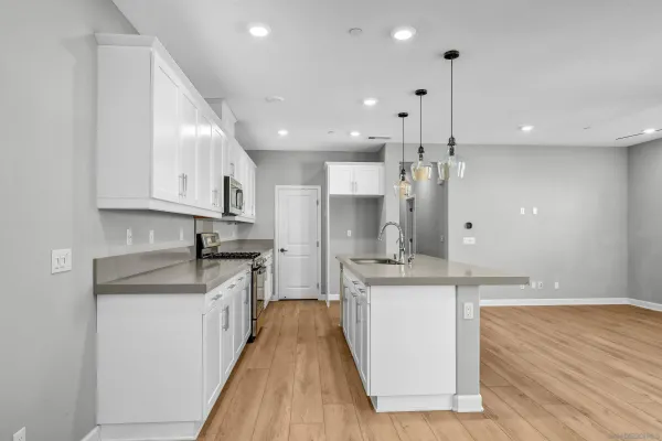 a large kitchen with stainless steel appliances kitchen island a stove a sink a refrigerator and a granite counter tops