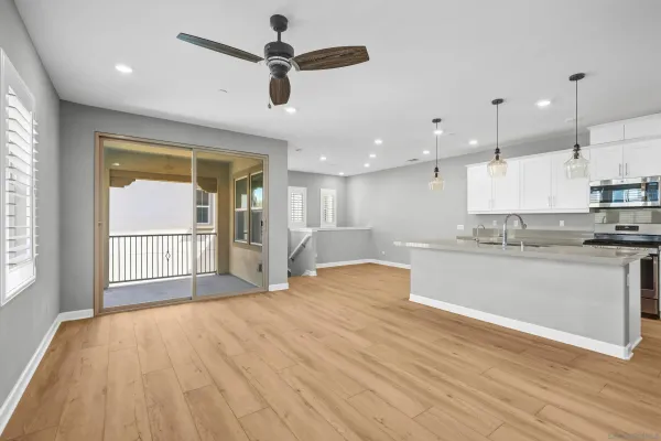 a large kitchen with kitchen island a sink stainless steel appliances and cabinets