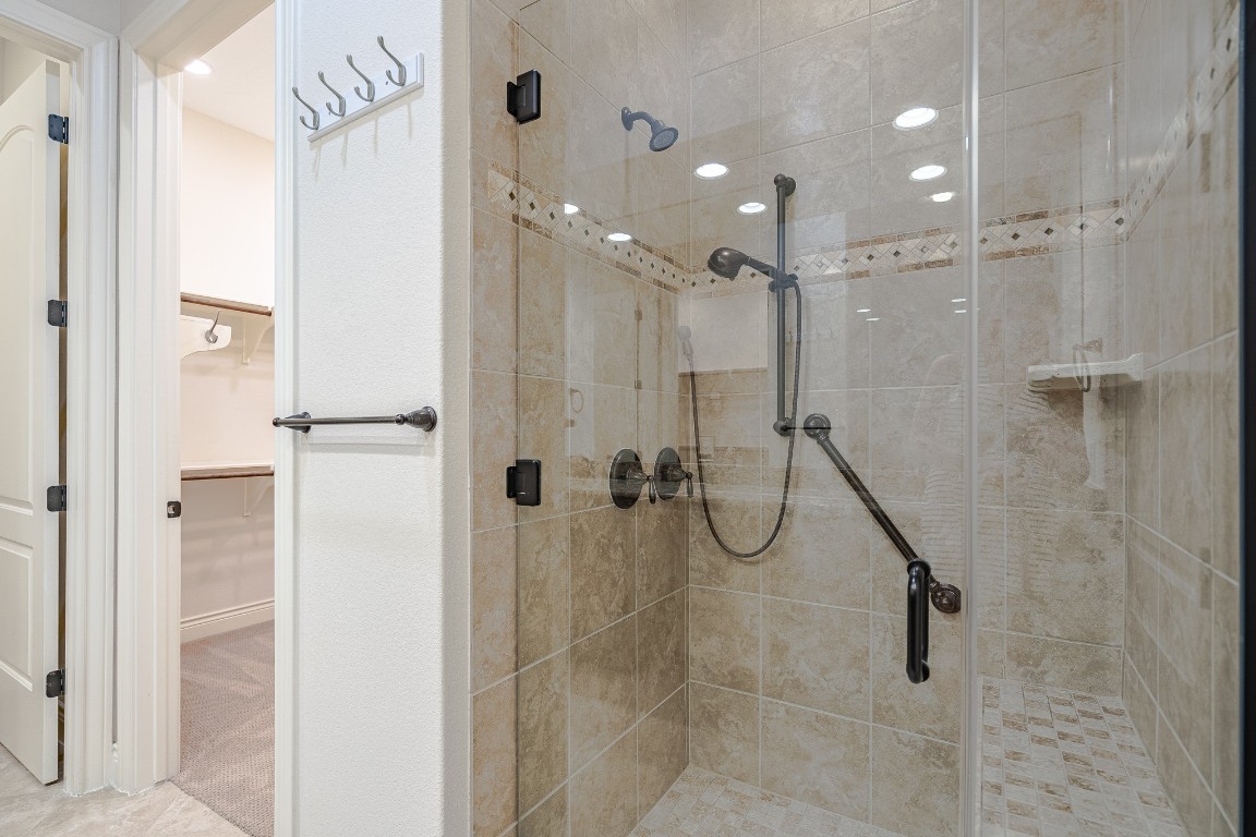 108-2 Rivalto Circle, Unit 5 Lakeway, TX 78734 - Photo 18 of 35 Bathroom with a spacious closet and a shower stall