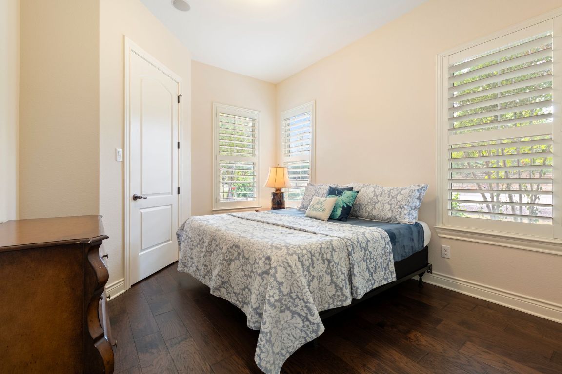 108-2 Rivalto Circle, Unit 5 Lakeway, TX 78734 - Photo 19 of 35 Bedroom with dark wood-type flooring and baseboards
