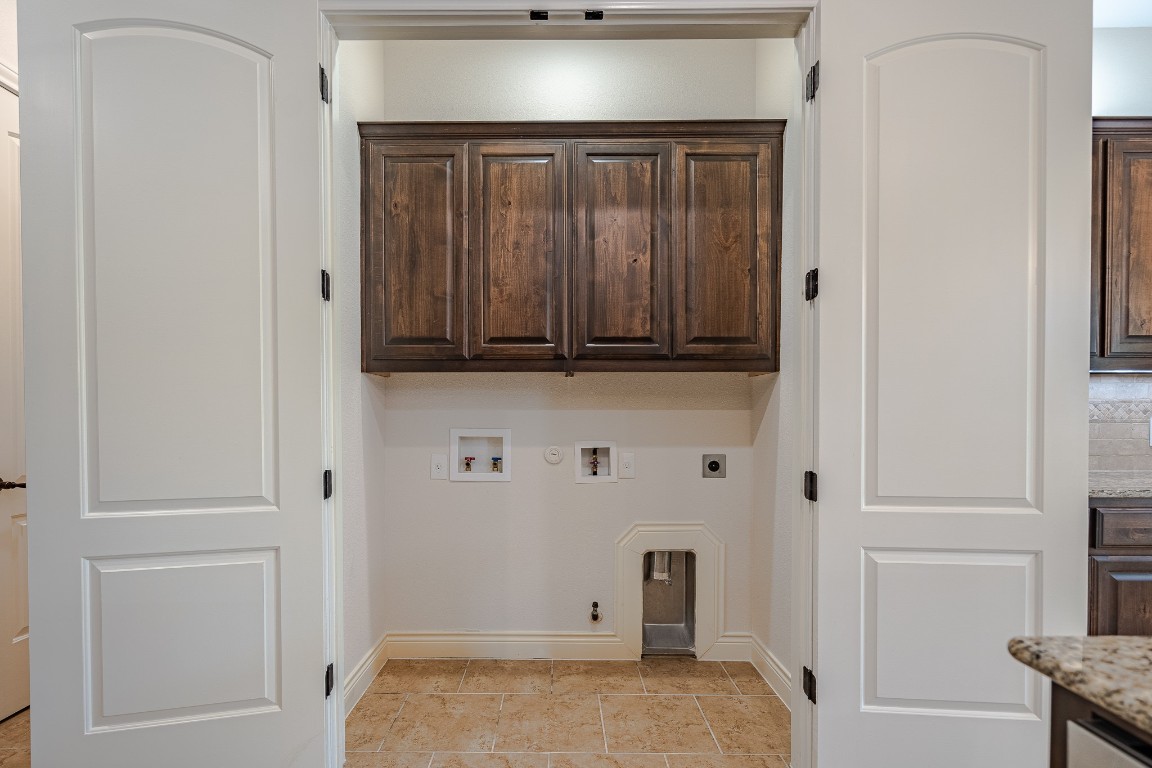 108-2 Rivalto Circle, Unit 5 Lakeway, TX 78734 - Photo 22 of 35 Laundry room with hookup for a gas dryer, hookup for a washing machine, cabinet space, hookup for an electric dryer, and light tile patterned floors