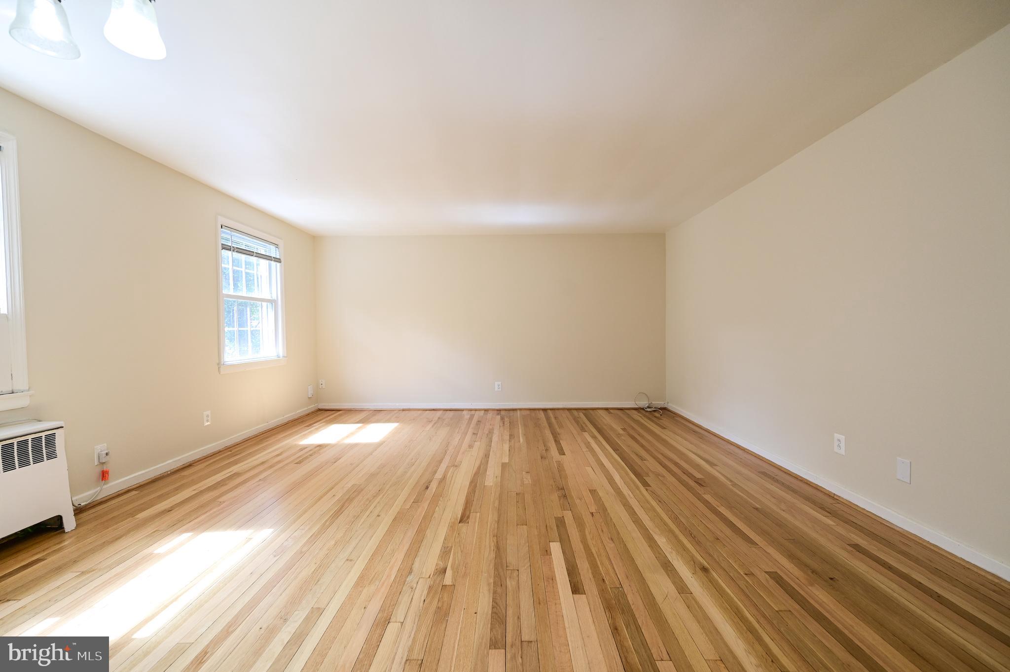 8331 Grubb Road, Unit G201 Silver Spring, MD 20910 - Photo 11 of 15 wooden floor in a empty room
