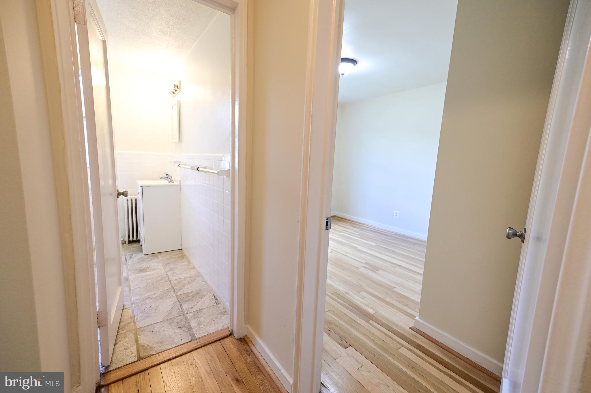 8331 Grubb Road, Unit G201 Silver Spring, MD 20910 - Photo 14 of 15 a view of a bathroom from a hallway