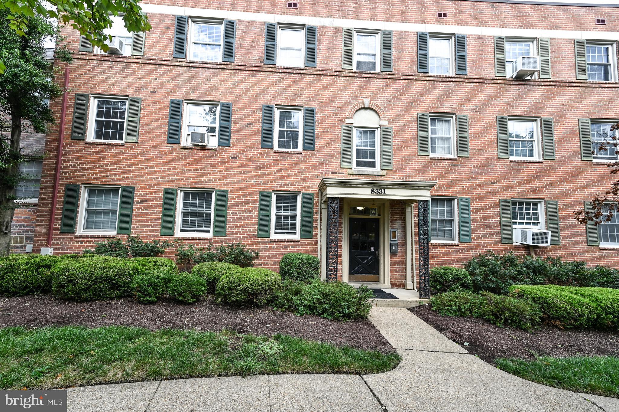 8331 Grubb Road, Unit G201 Silver Spring, MD 20910 - Photo 2 of 15 a front view of a building with garden