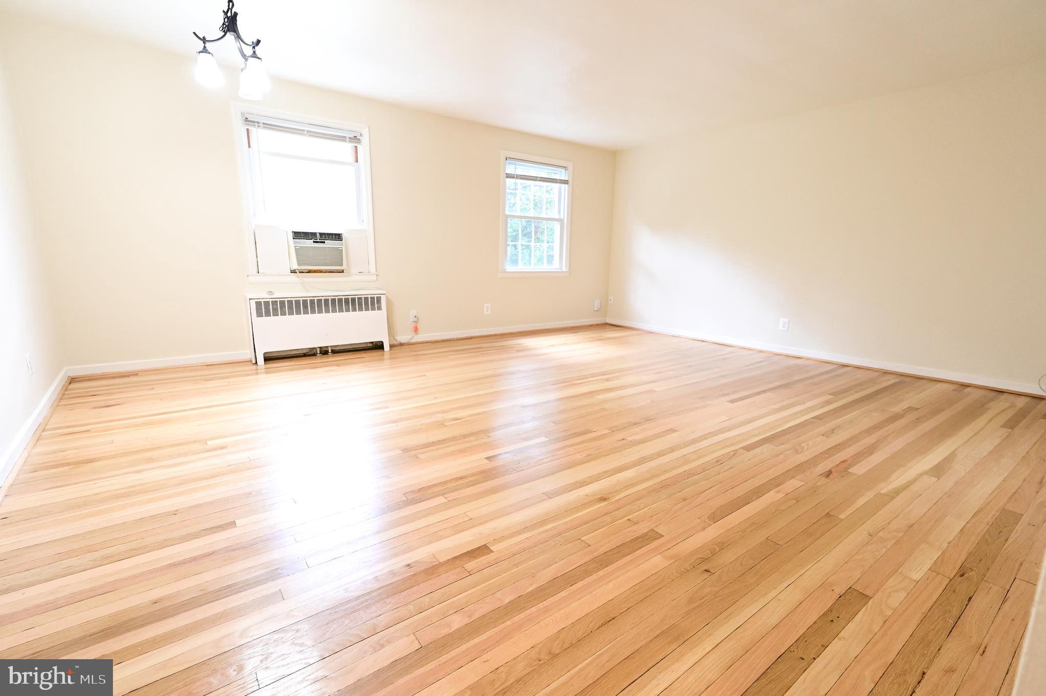 8331 Grubb Road, Unit G201 Silver Spring, MD 20910 - Photo 5 of 15 a view of empty room with wooden floor and fan