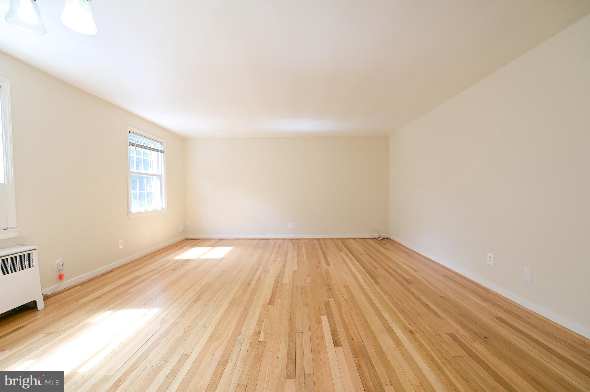 8331 Grubb Road, Unit G201 Silver Spring, MD 20910 - Photo 10 of 15 an empty room with wooden floor and windows