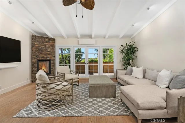 a living room with furniture a fireplace and a flat screen tv