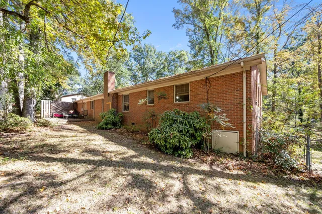 a backyard of a house with plants and trees