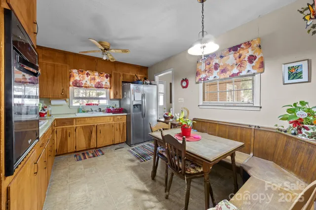 a very nice looking dining room with furniture window and wooden floor