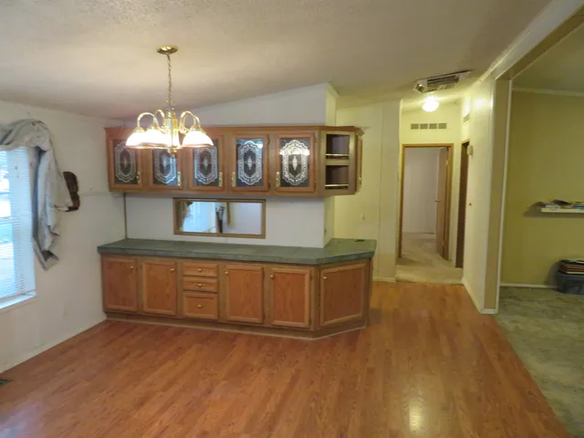 a view of a kitchen cabinets and a livingroom