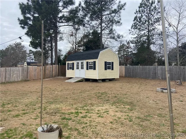 a white house that has a tree in front of it