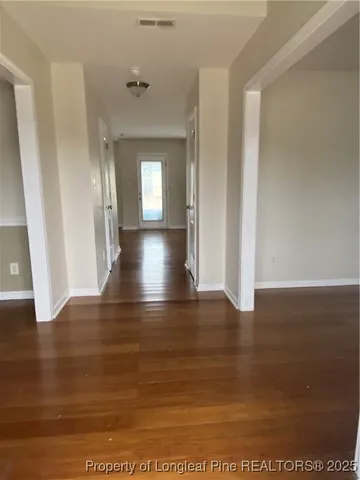 a view of a room with wooden floor