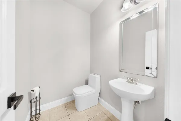 a large kitchen with kitchen island white cabinets and stainless steel appliances