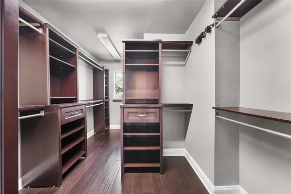 a view of walk in closet with empty racks