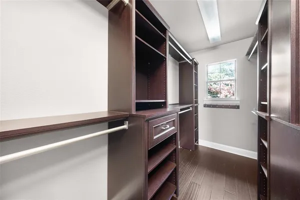 a view of walk in closet with empty racks