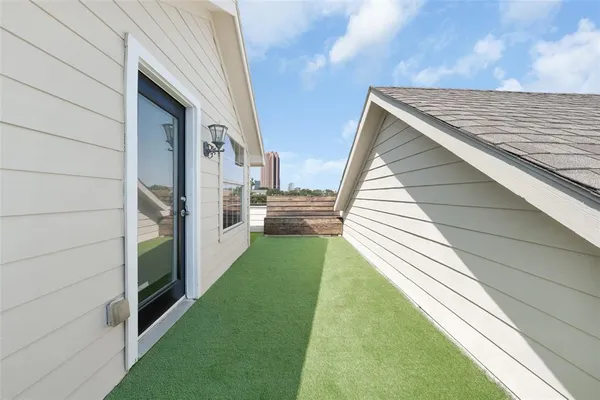 a view of staircase with railing and a window