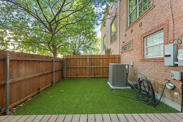 a view of outdoor sitting area with couch and wooden fence
