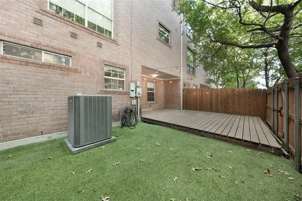 a view of backyard with seating space and wooden fence