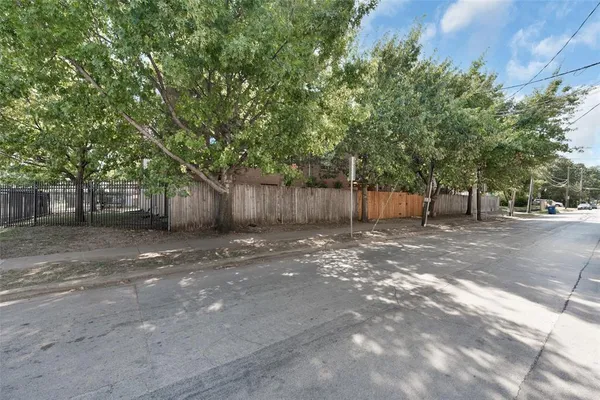 a row of palm trees in front of house