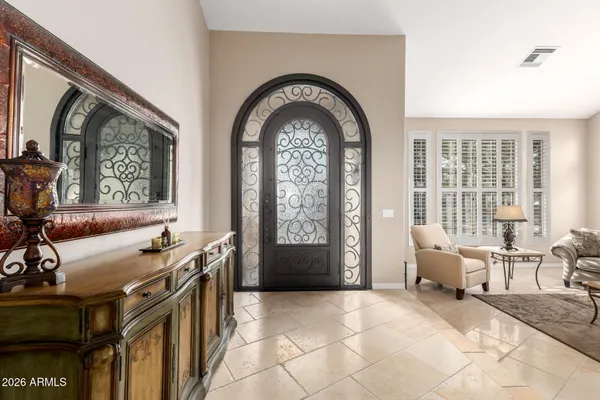 a kitchen with stainless steel appliances granite countertop a stove top oven a sink dishwasher and a refrigerator with wooden cabinets