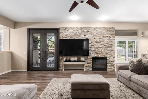 an empty room with ceiling fan and window