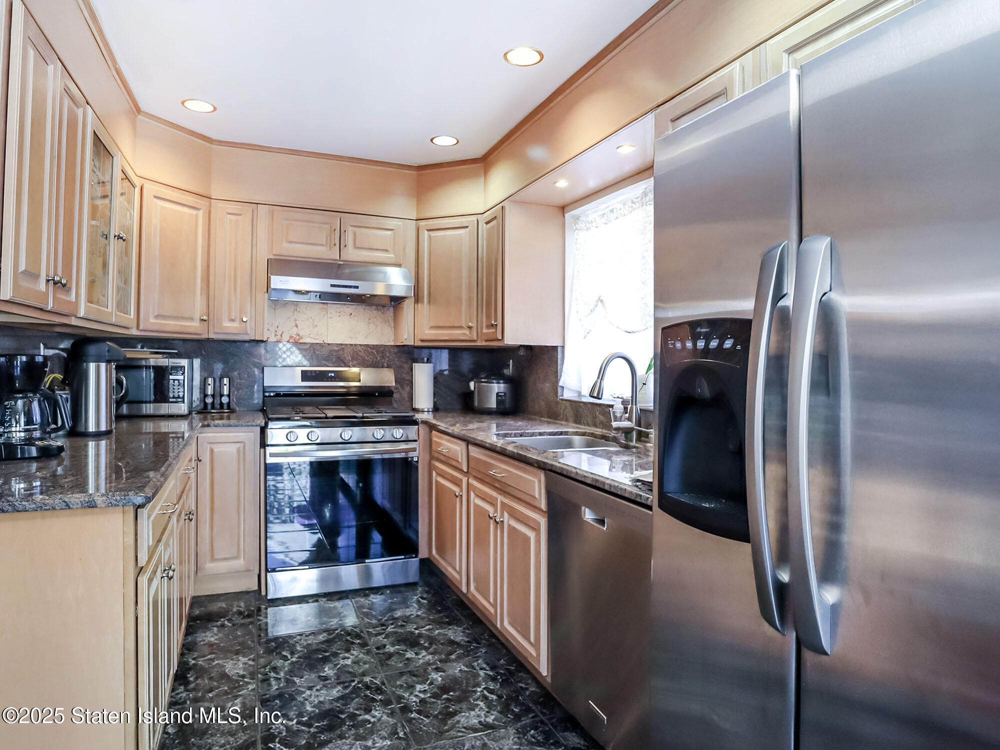45 Fairlawn Loop Staten Island, NY 10308 - Photo 11 of 49 a kitchen with stainless steel appliances granite countertop a refrigerator a stove and a sink with wooden floor