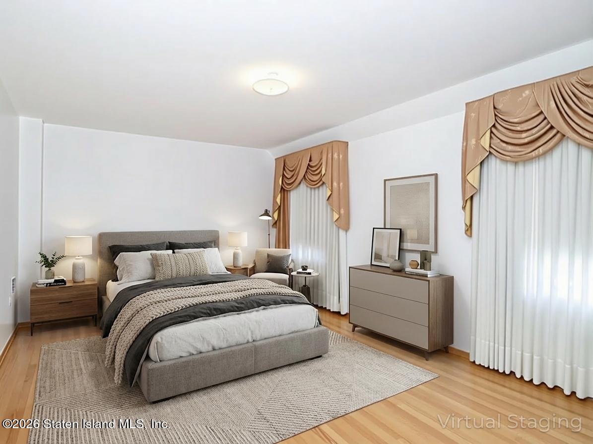 45 Fairlawn Loop Staten Island, NY 10308 - Photo 16 of 49 a bedroom with a bed and dresser with mirror