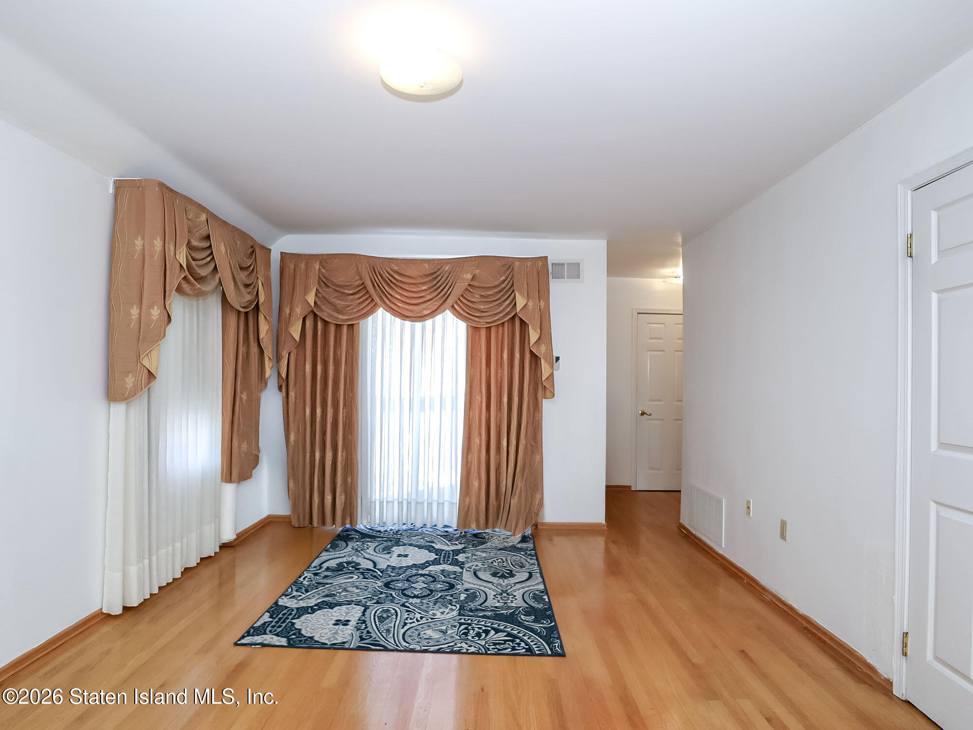 45 Fairlawn Loop Staten Island, NY 10308 - Photo 17 of 49 a view of livingroom with hardwood floor and hallway