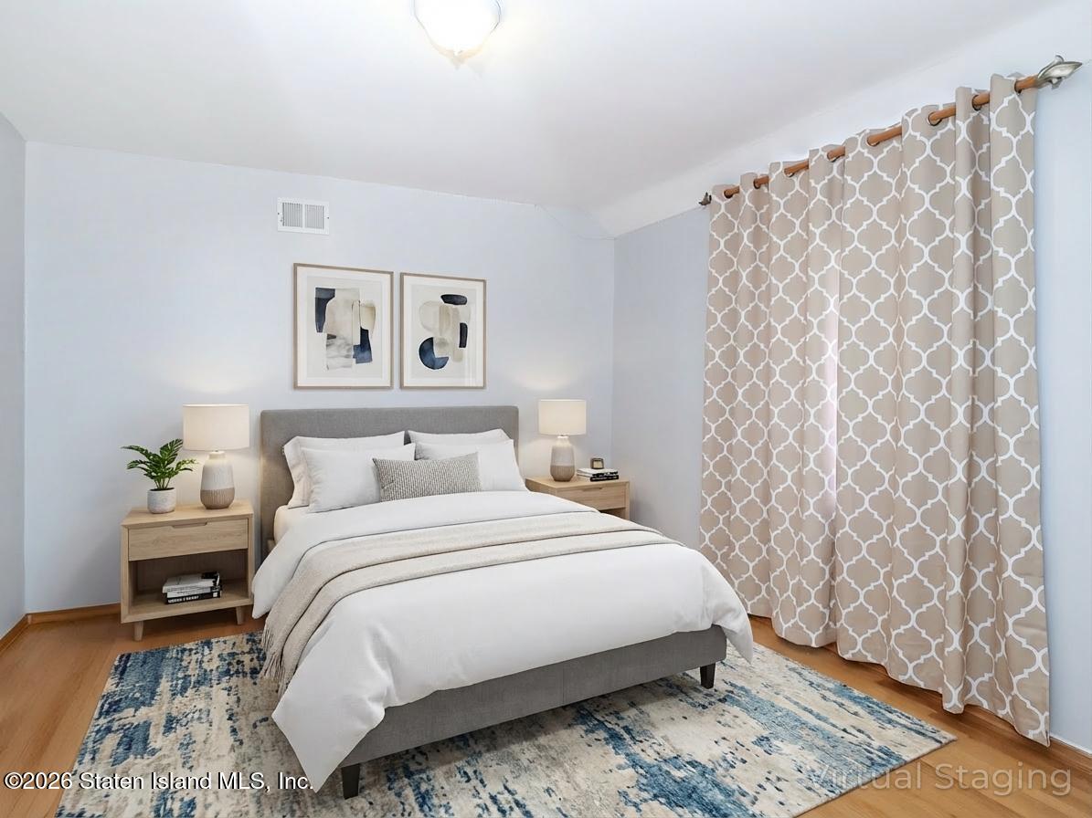 45 Fairlawn Loop Staten Island, NY 10308 - Photo 21 of 49 a bedroom with a bed and a painting on the wall