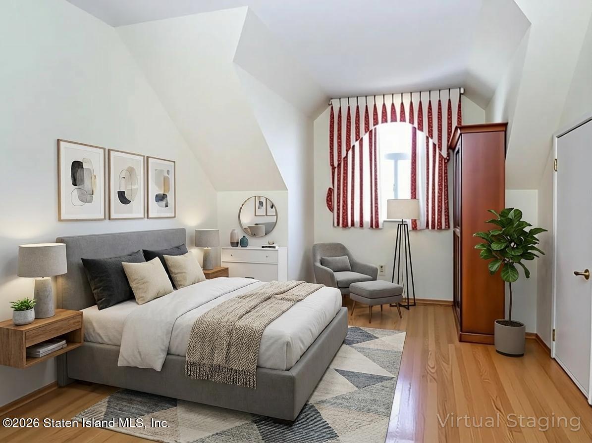 45 Fairlawn Loop Staten Island, NY 10308 - Photo 24 of 49 a bedroom with a bed table and a large window