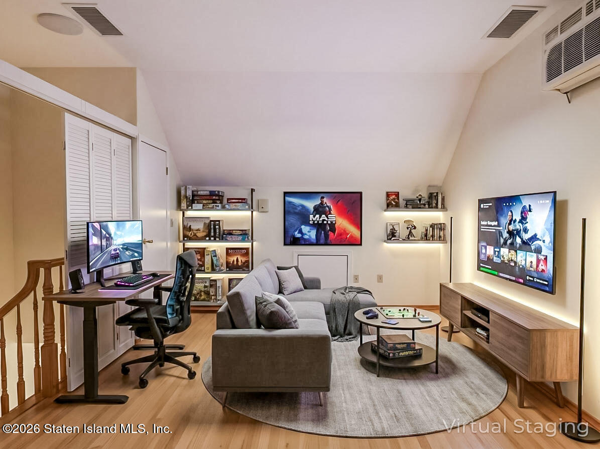 45 Fairlawn Loop Staten Island, NY 10308 - Photo 26 of 49 a living room with furniture a rug and a wall painting
