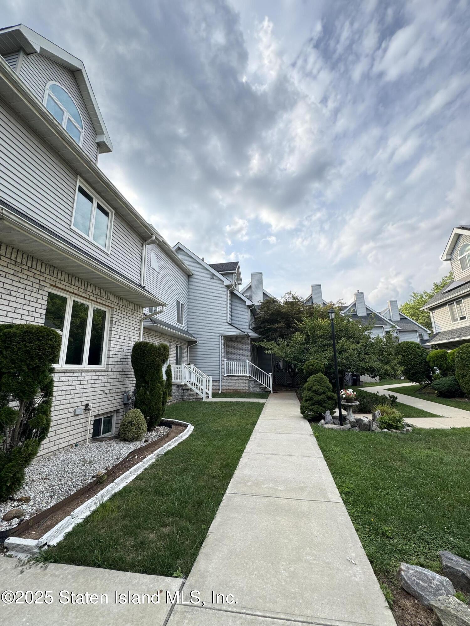 45 Fairlawn Loop Staten Island, NY 10308 - Photo 44 of 49 a front view of a house with garden