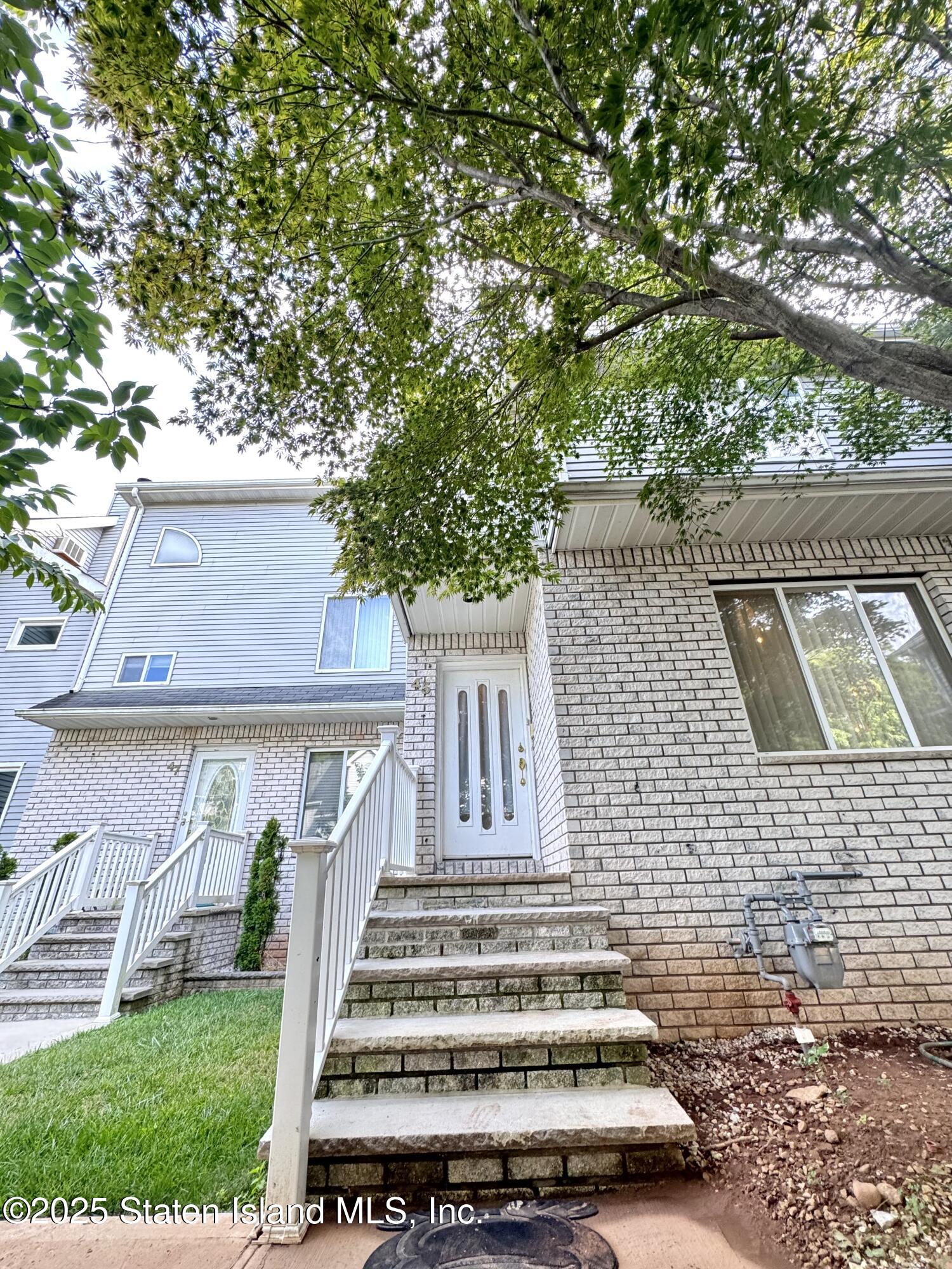 45 Fairlawn Loop Staten Island, NY 10308 - Photo 45 of 49 a view of a yard in front of a house with a fountain