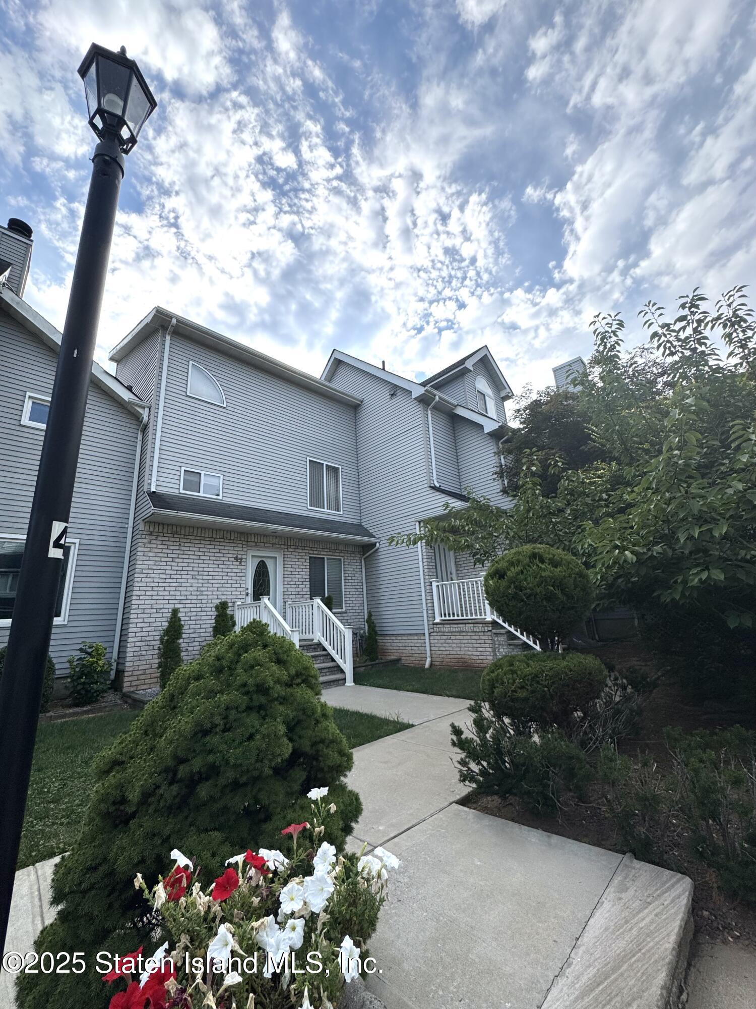 45 Fairlawn Loop Staten Island, NY 10308 - Photo 48 of 49 a front view of a house with a yard and tree s