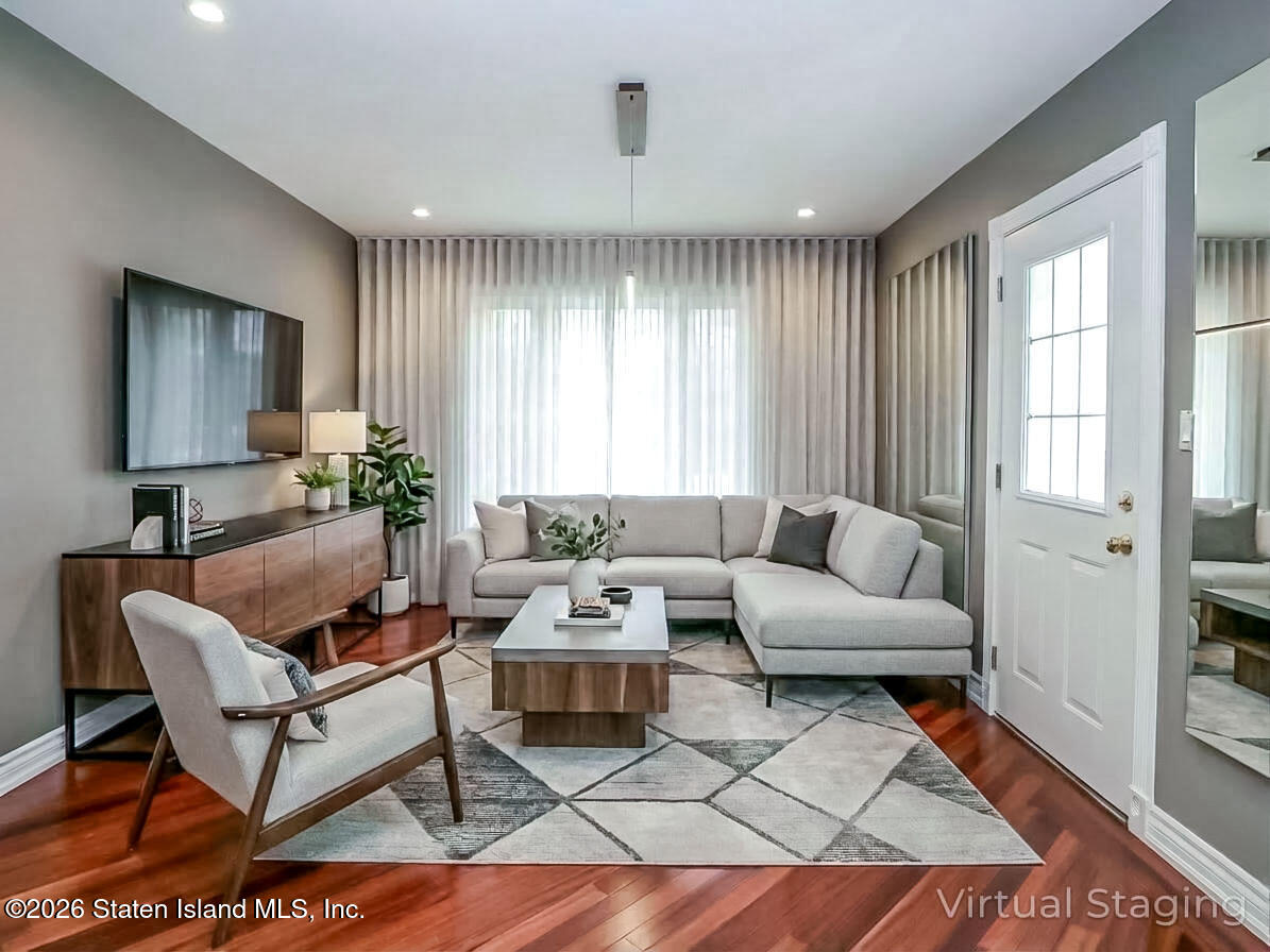 45 Fairlawn Loop Staten Island, NY 10308 - Photo 6 of 49 a living room with furniture and a large window