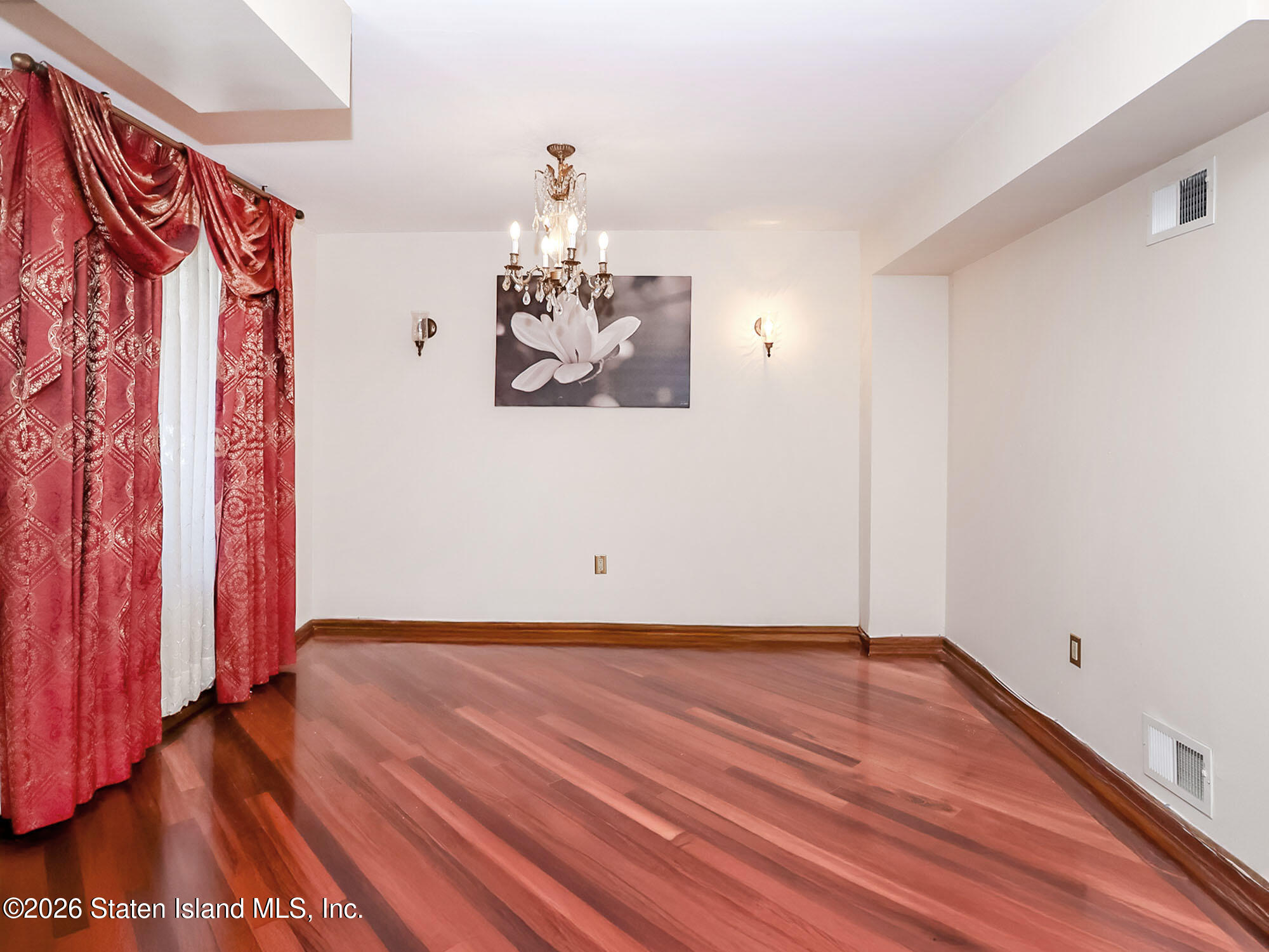45 Fairlawn Loop Staten Island, NY 10308 - Photo 7 of 49 a view of a room with wooden floor and bench